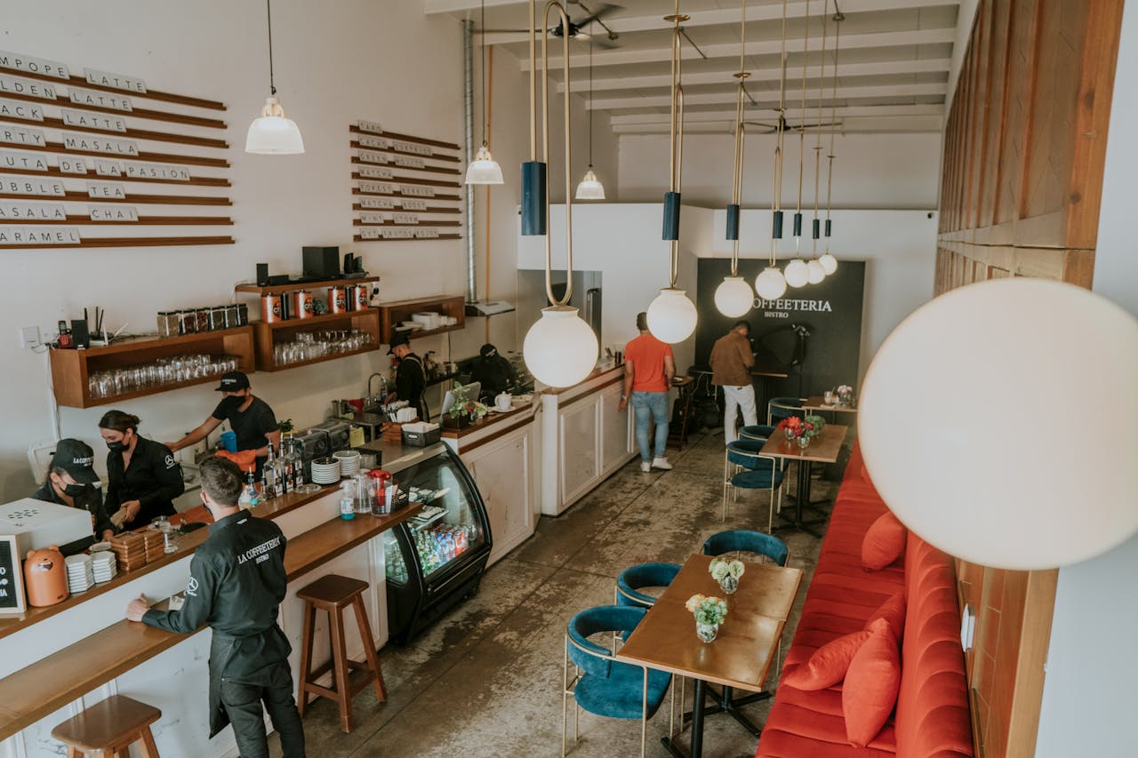 Restaurant workers standing around in an empty restaurant