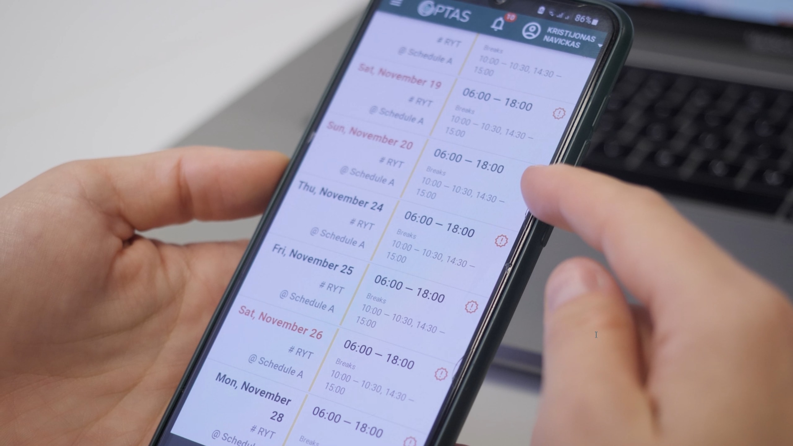 Picture of a staff member reviewing his updated schedule on a phone